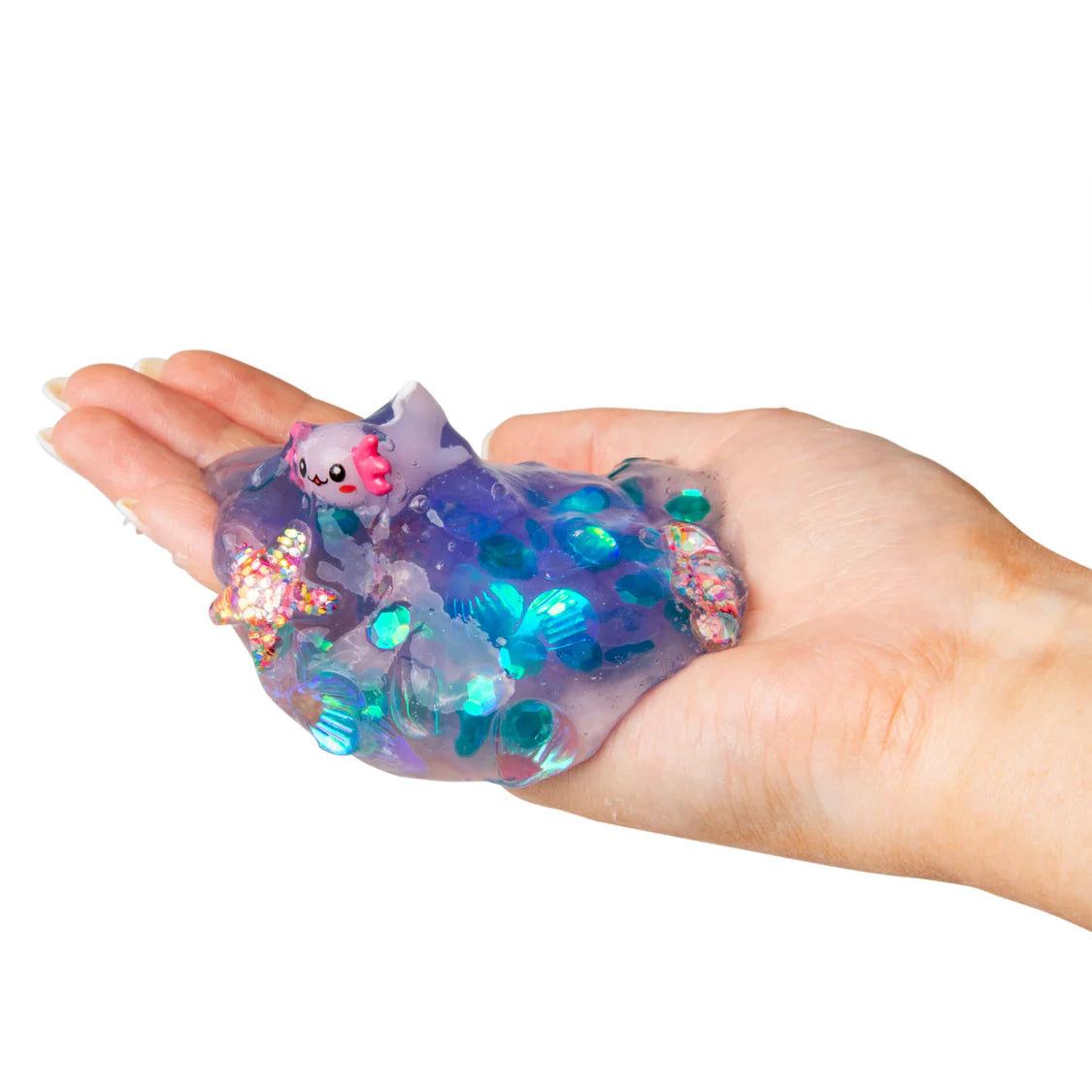 Hand holding a colorful, iridescent slime toy with a small plush toy inside on a white background