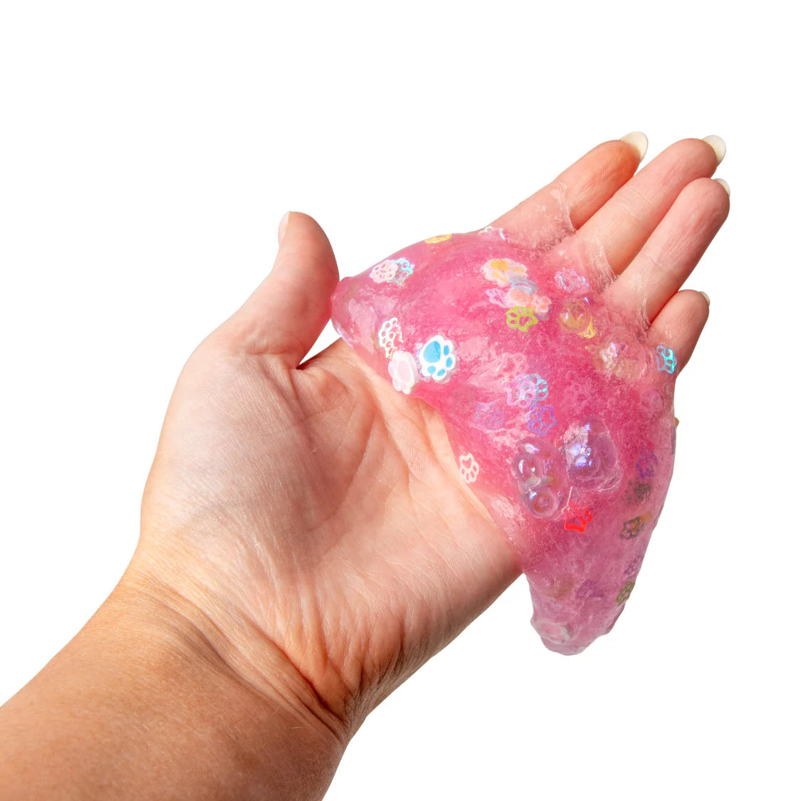 Pink slime with floral designs held in a hand against a white background