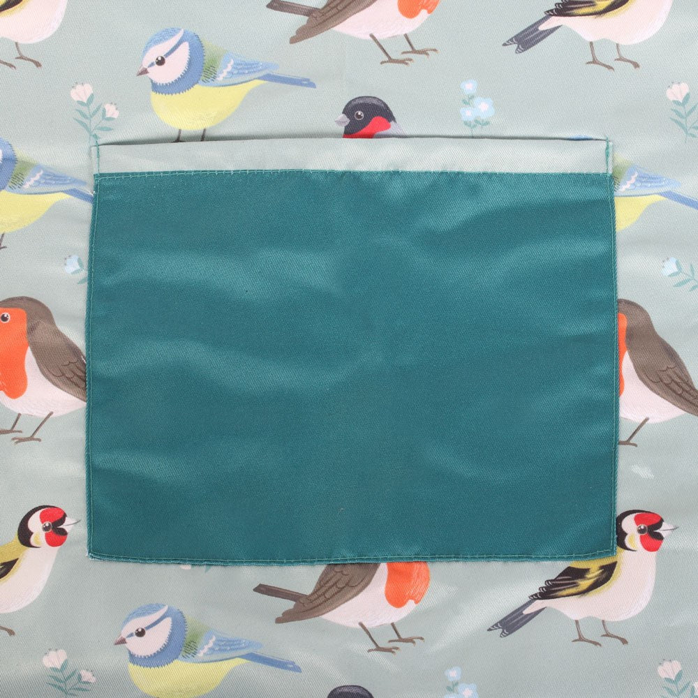Teal fabric pocket on a background with bird illustrations on an apron
