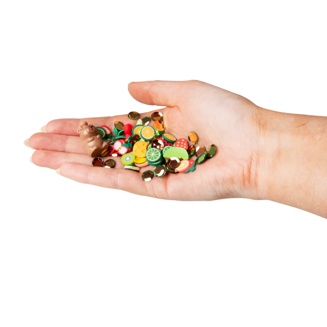 Hand holding colourful toys on a white background