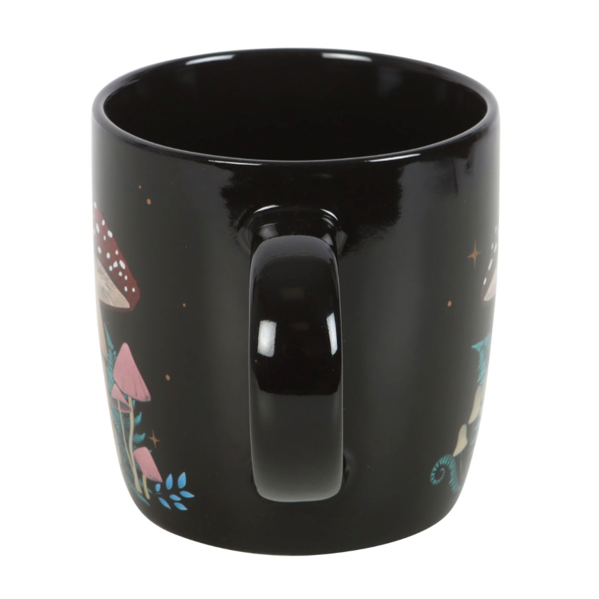 black forest mushroom mug with red, cream and pink mushrooms handle view