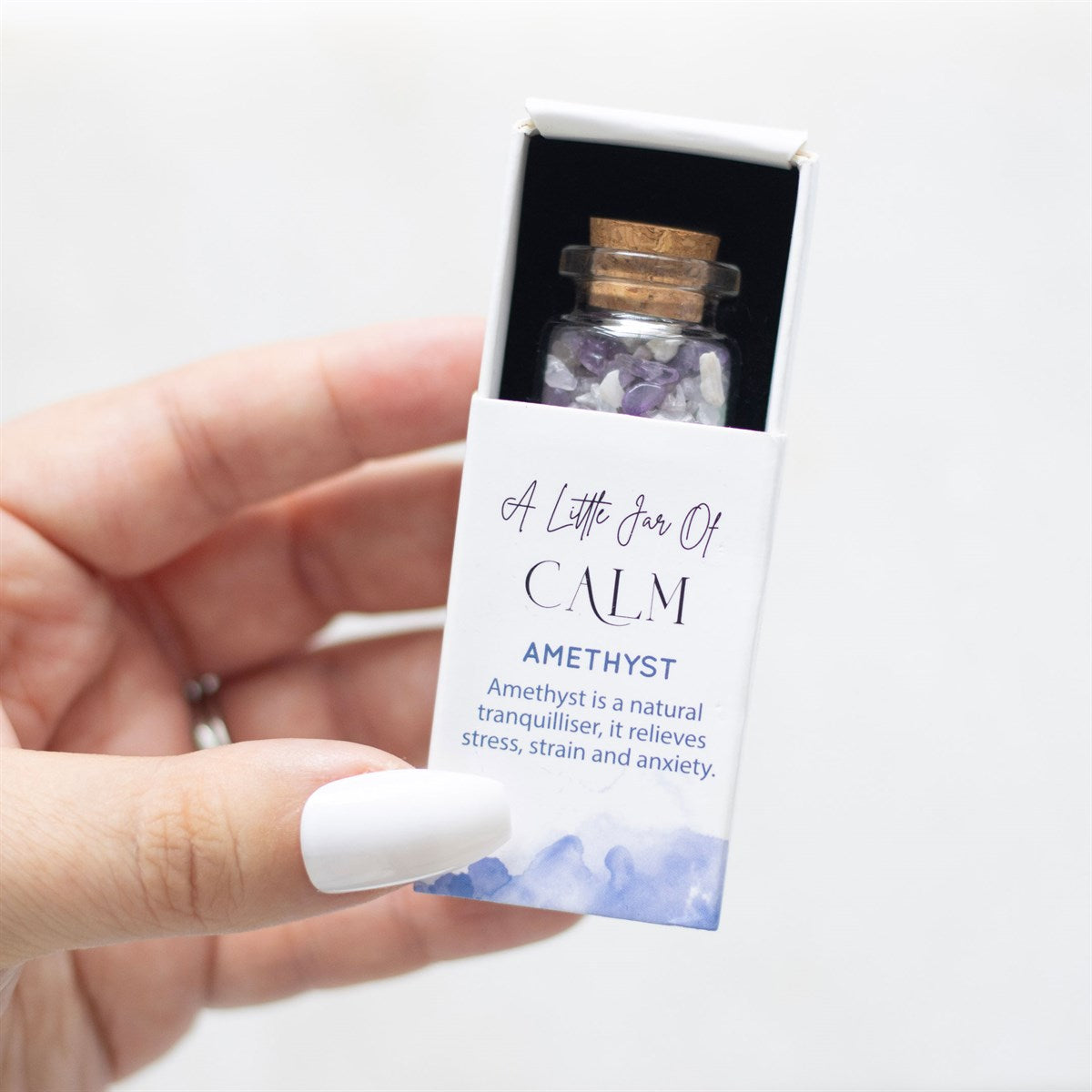 Little Glass Jar of Amethyst Crystal in a Matchbox open
