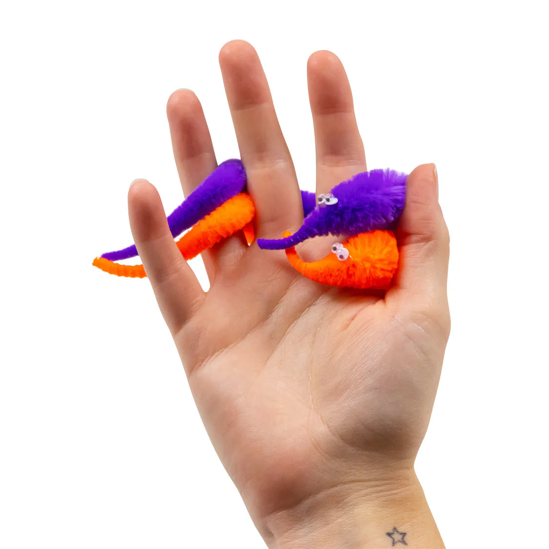 Hand holding a small, colorful toy resembling a caterpillar on a white background