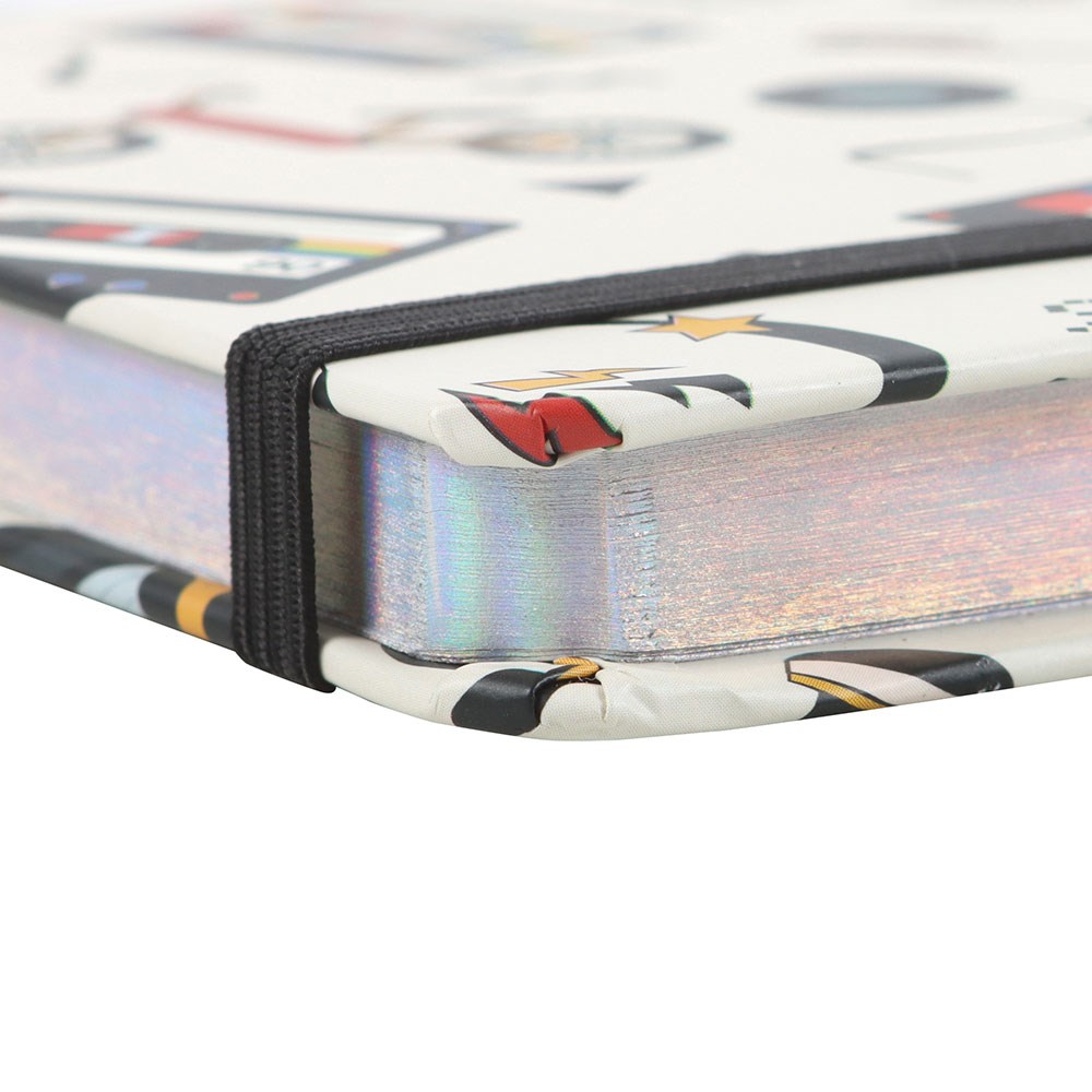 Close-up of holographic notebook edge with a colourful design on a white background