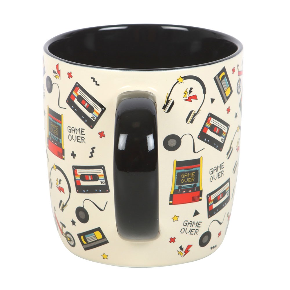 Mug with retro gaming design featuring cassette tapes and 'Game Over' text on a white background.