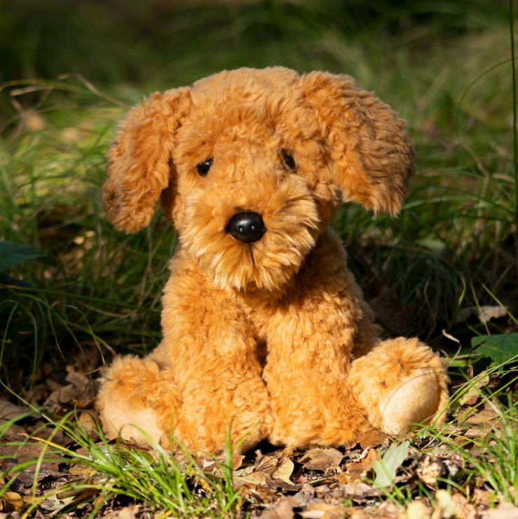 plush Cockapoo toy in nature