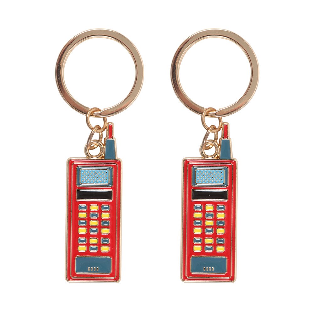 Two red walkie talkie keychains on a white background