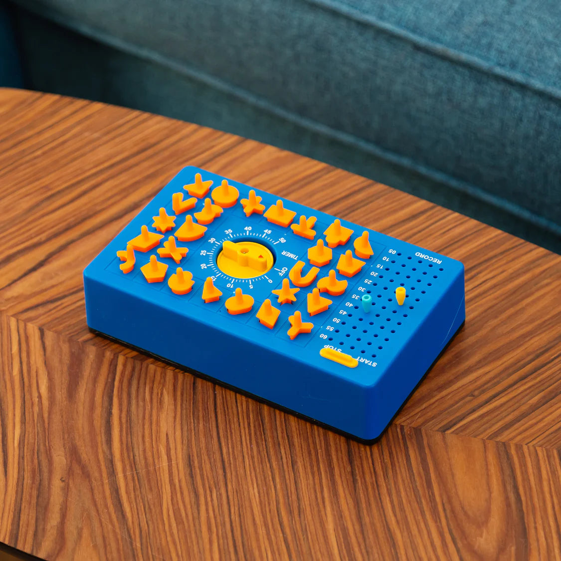 Blue and orange Time Shock game on a wooden table with a blue couch in the background