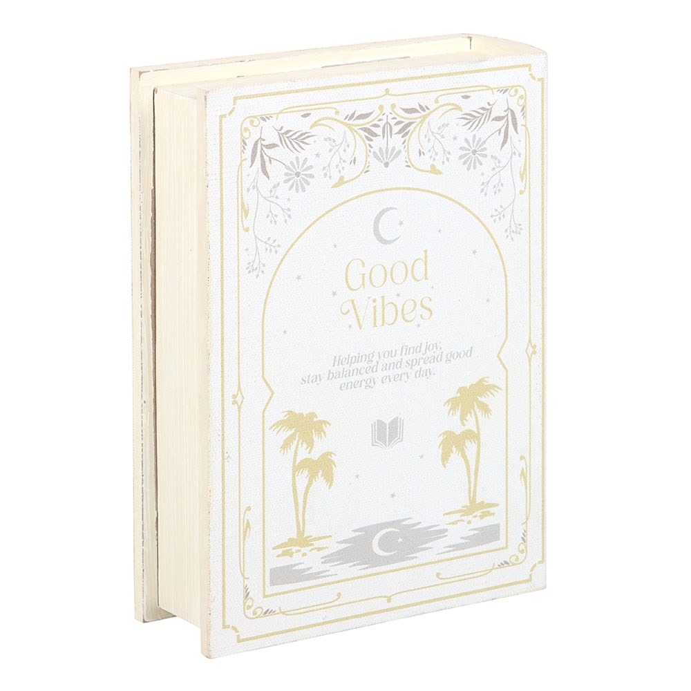 Decorative storage box book titled 'Good Vibes' with palm tree and moon design on a white background