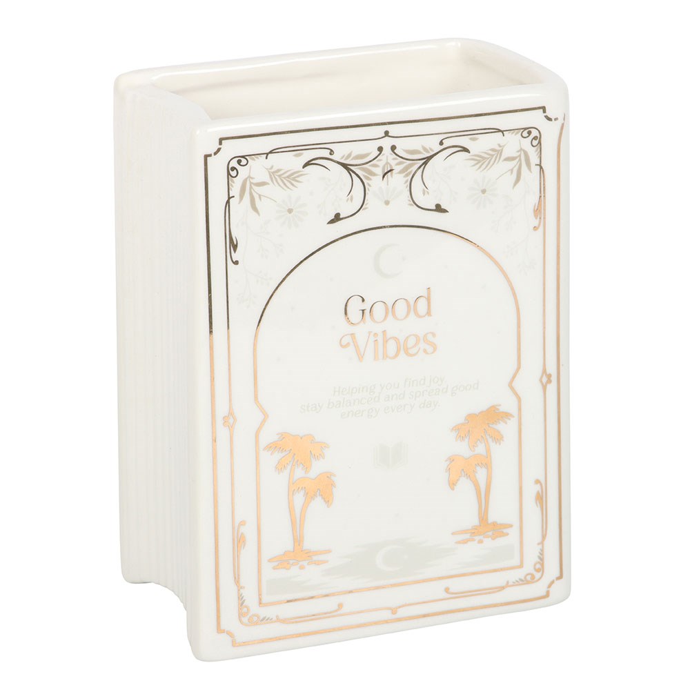 Decorative book shaped vase with 'Good Vibes' text and palm tree designs on a white background