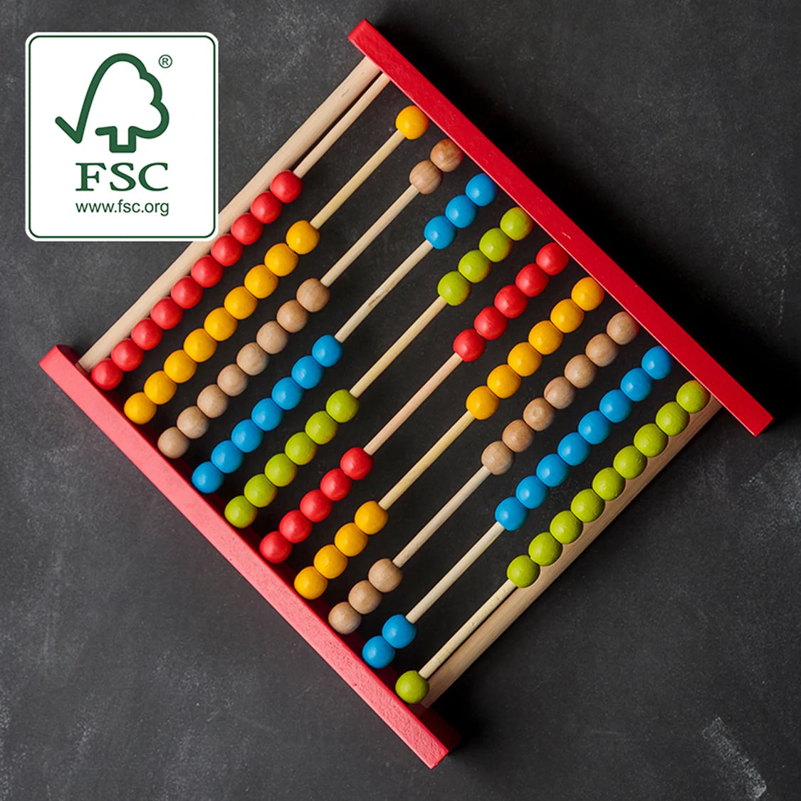 Colorful abacus on a dark background with FSC logo