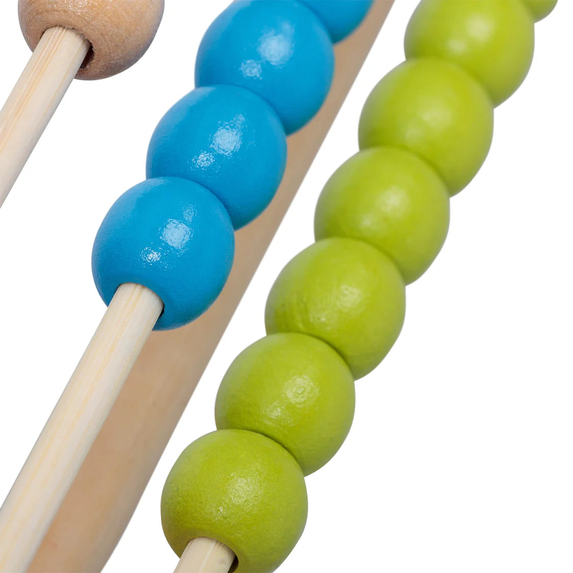 Close-up of wooden sticks with blue and green beads on a white background