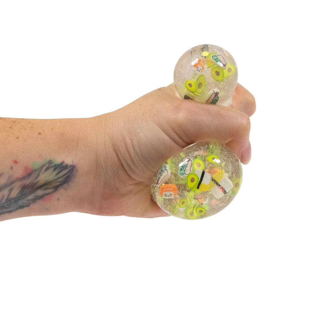 Hand holding a clear stress ball with colorful designs on a white background