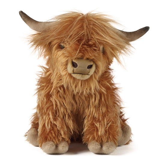 Plush toy Highland cow on a white background