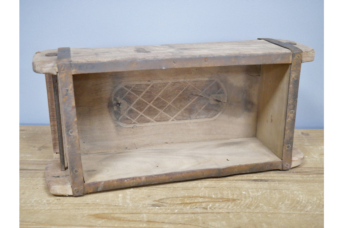 Wooden brick mould on a wooden surface with a blue background