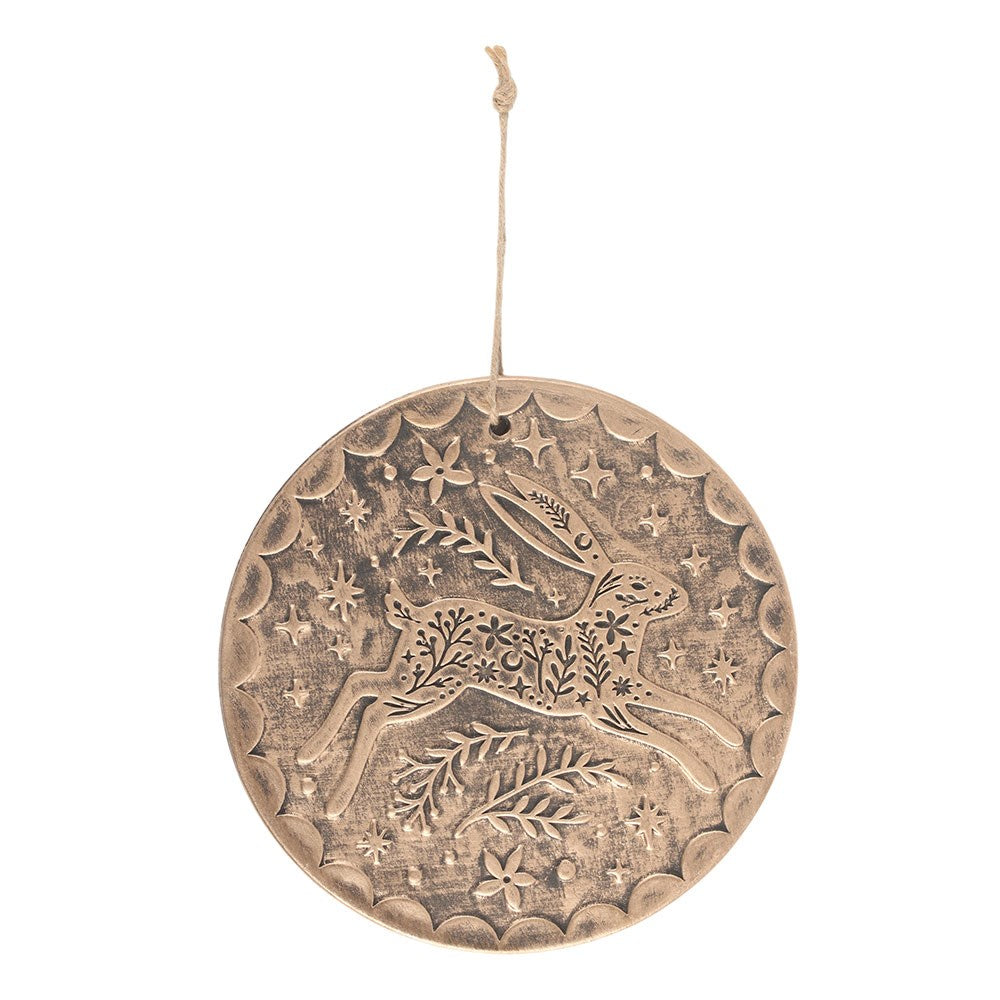 Decorative round bronze terracotta hanging piece with hare and floral design on a white background