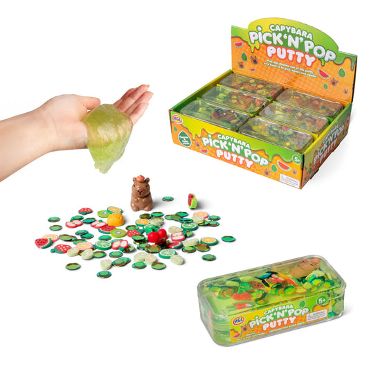 Capybara Pick 'n' Pop Putty toy set with a hand holding green putty, packaging, and scattered pieces on a white background.