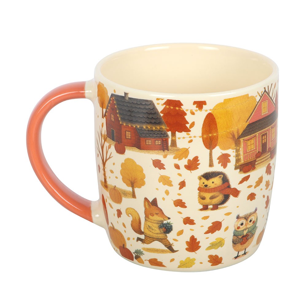 Mug with autumn-themed design featuring animals and houses on a white background