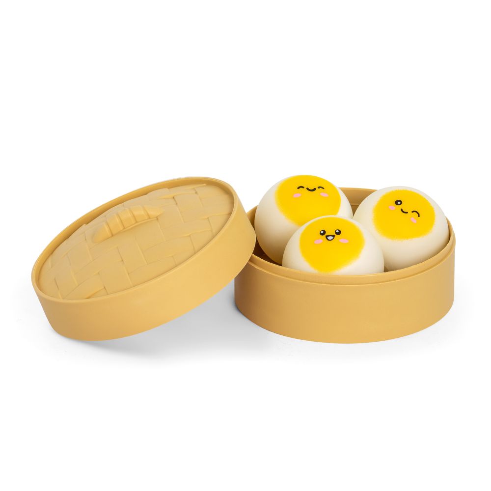 Yellow container with three round, cartoon-like squishy dumplings on a white background