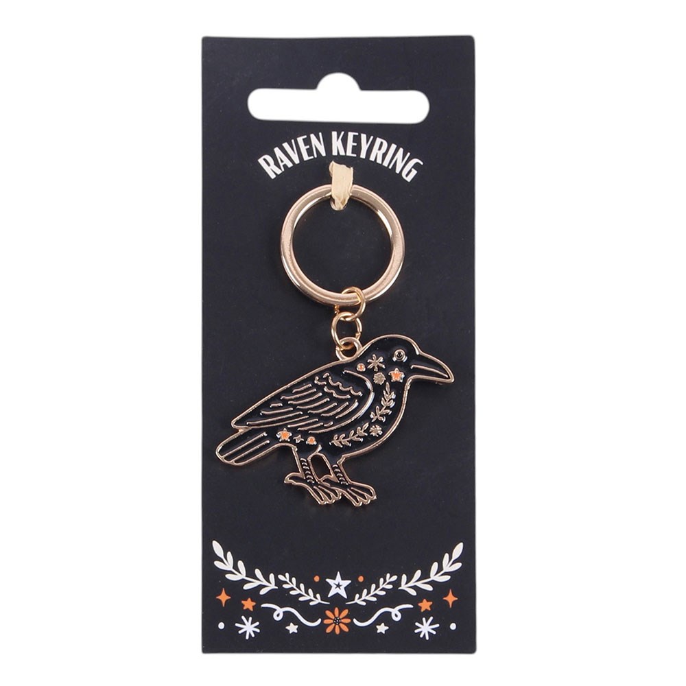 Raven keyring on a black card with decorative elements