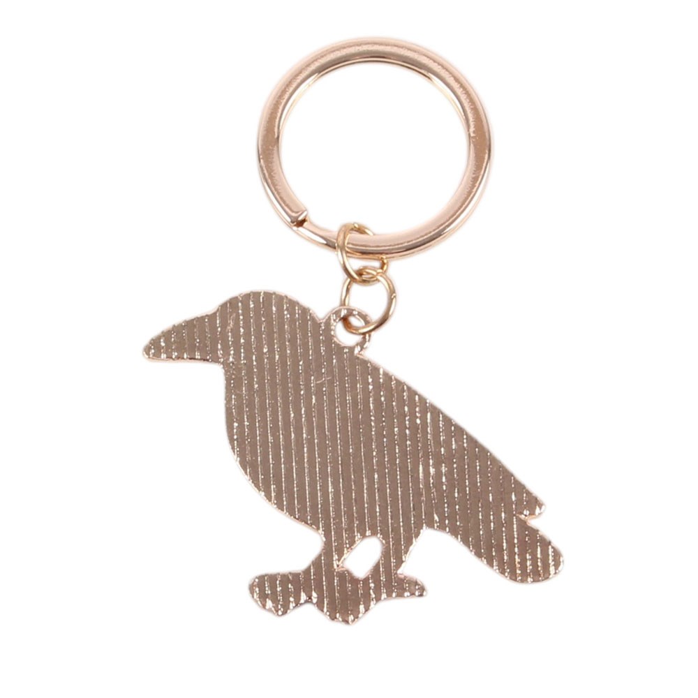 Rose gold bird-shaped keychain on a white background