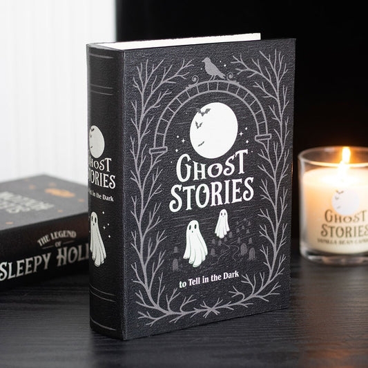 Book storage box titled 'Ghost Stories to Tell in the Dark' with a candle on a dark surface.