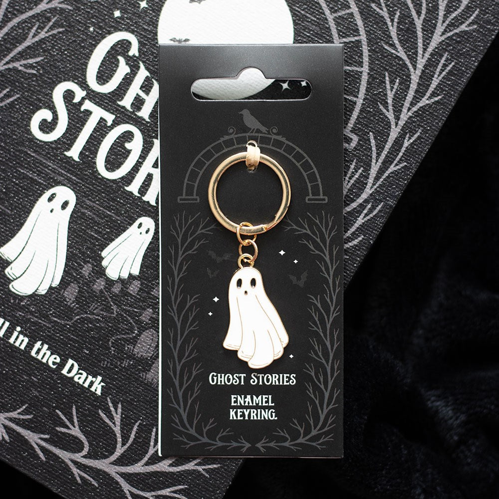 Ghost Stories enamel keyring on a black card with ghost illustrations