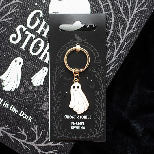 Ghost Stories enamel keyring on a black card with ghost illustrations