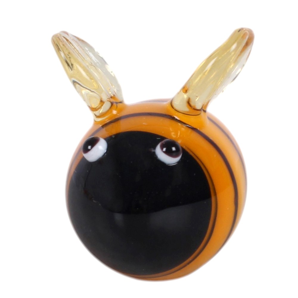 A small decorative glass bee figurine with a glossy black face, orange body, and translucent amber wings, shown on a plain white background.