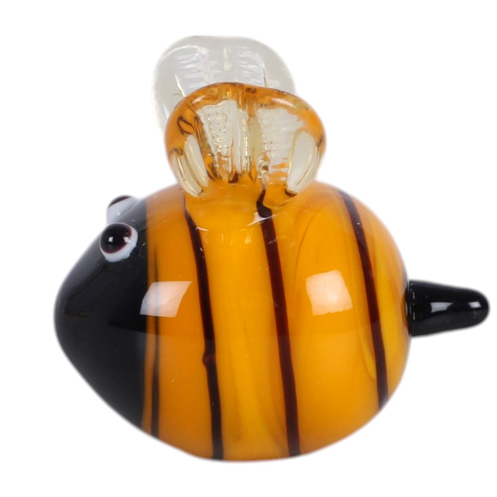 A hand-blown glass bee figurine with a glossy black head, orange and yellow striped body, and clear wings, shown on a plain white background.