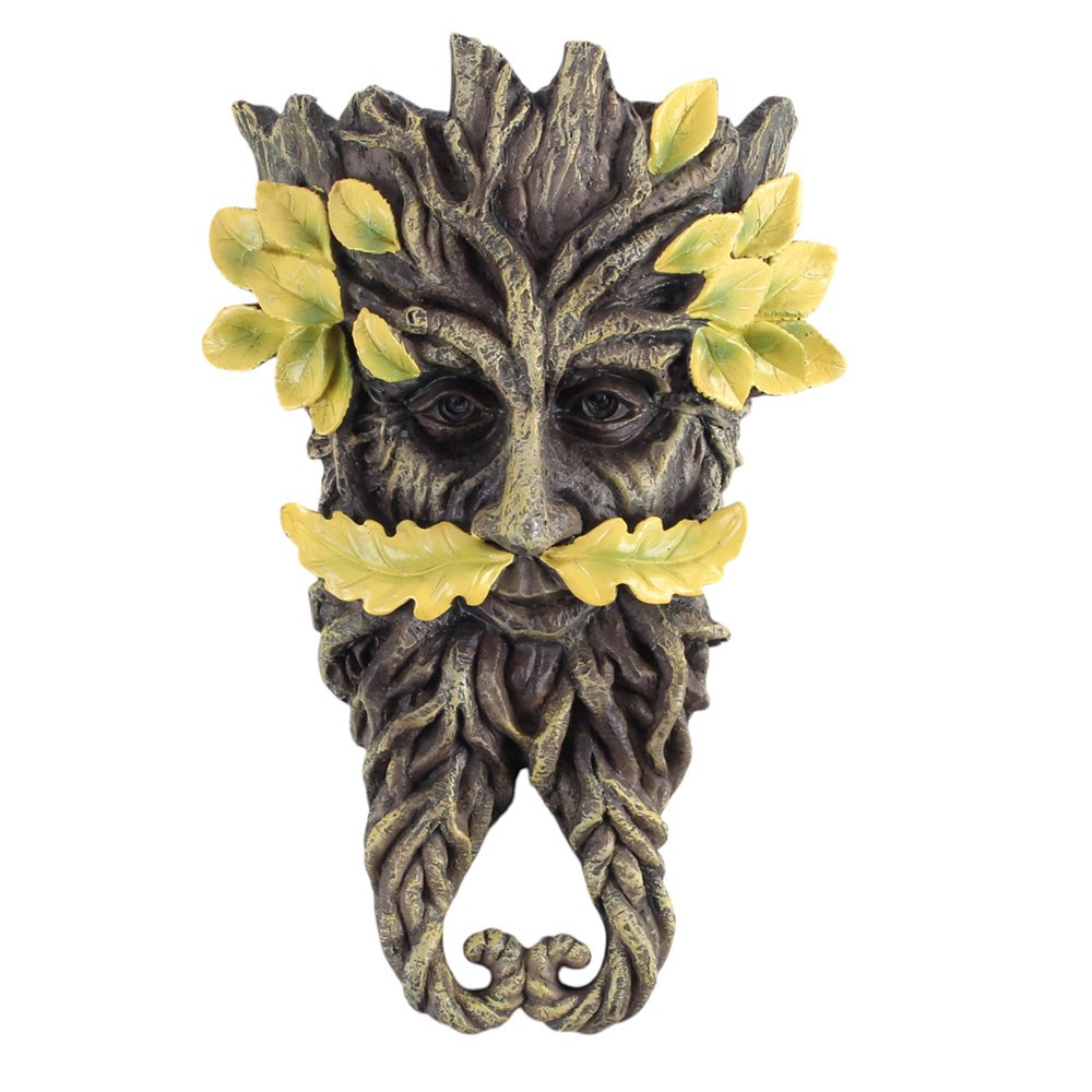 Decorative green man plaque of a tree-like creature with leaves on a white background
