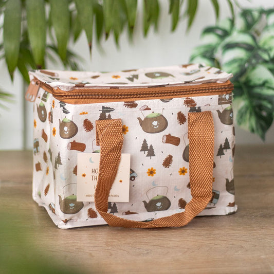  insulated lunch bag with nature-themed design on a wooden surface with plants in the background
