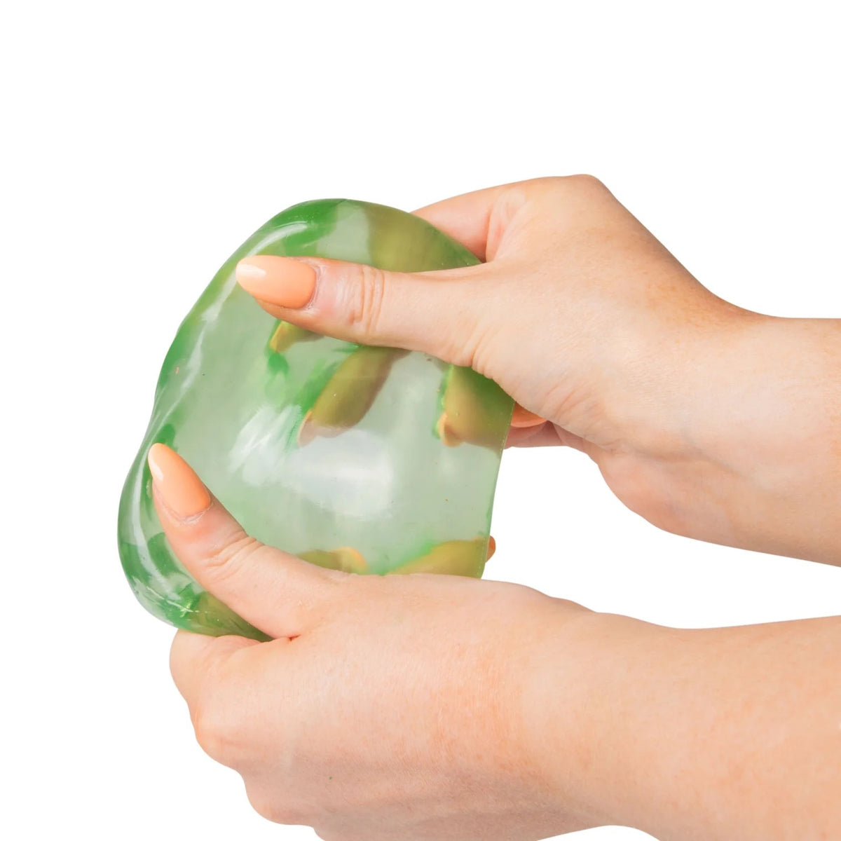 Green Scrunchems Sugar Cube being held by a hand on a white background