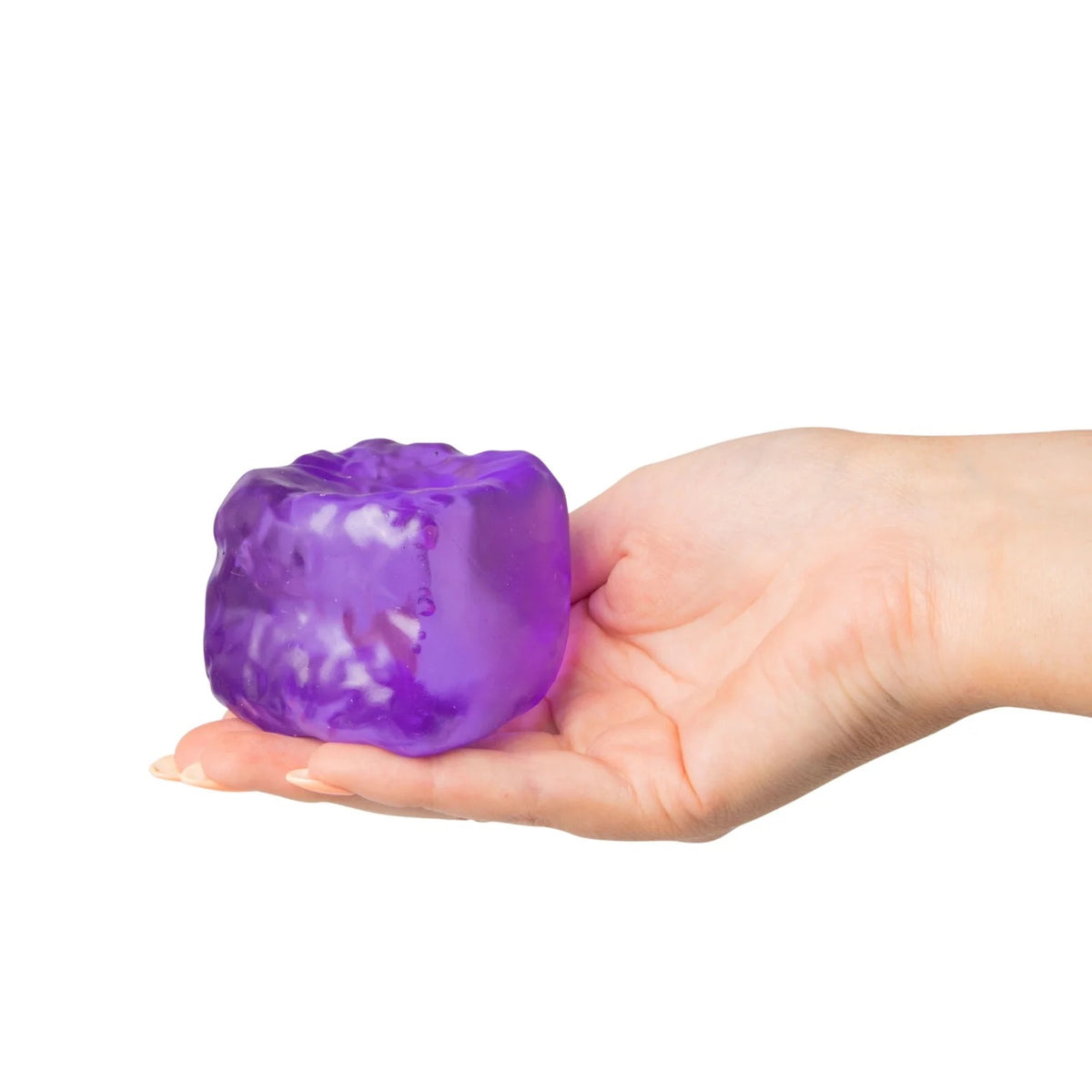 Hand holding a purple Scrunchems Sugar Cube against a white background