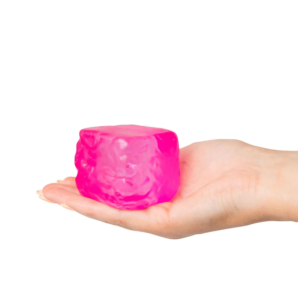 Hand holding a pink Scrunchems Sugar Cube against a white background