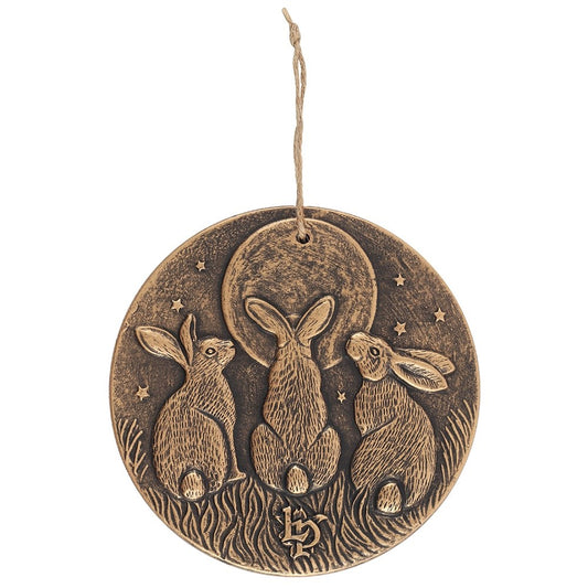 terracotta Bronze effect plaque with three rabbits looking up at a moon design 