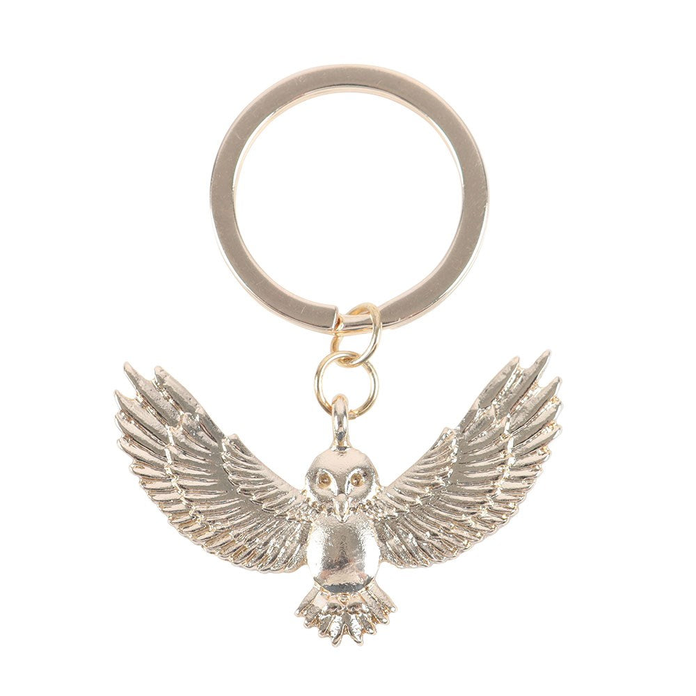 Gold owl keychain on a white background