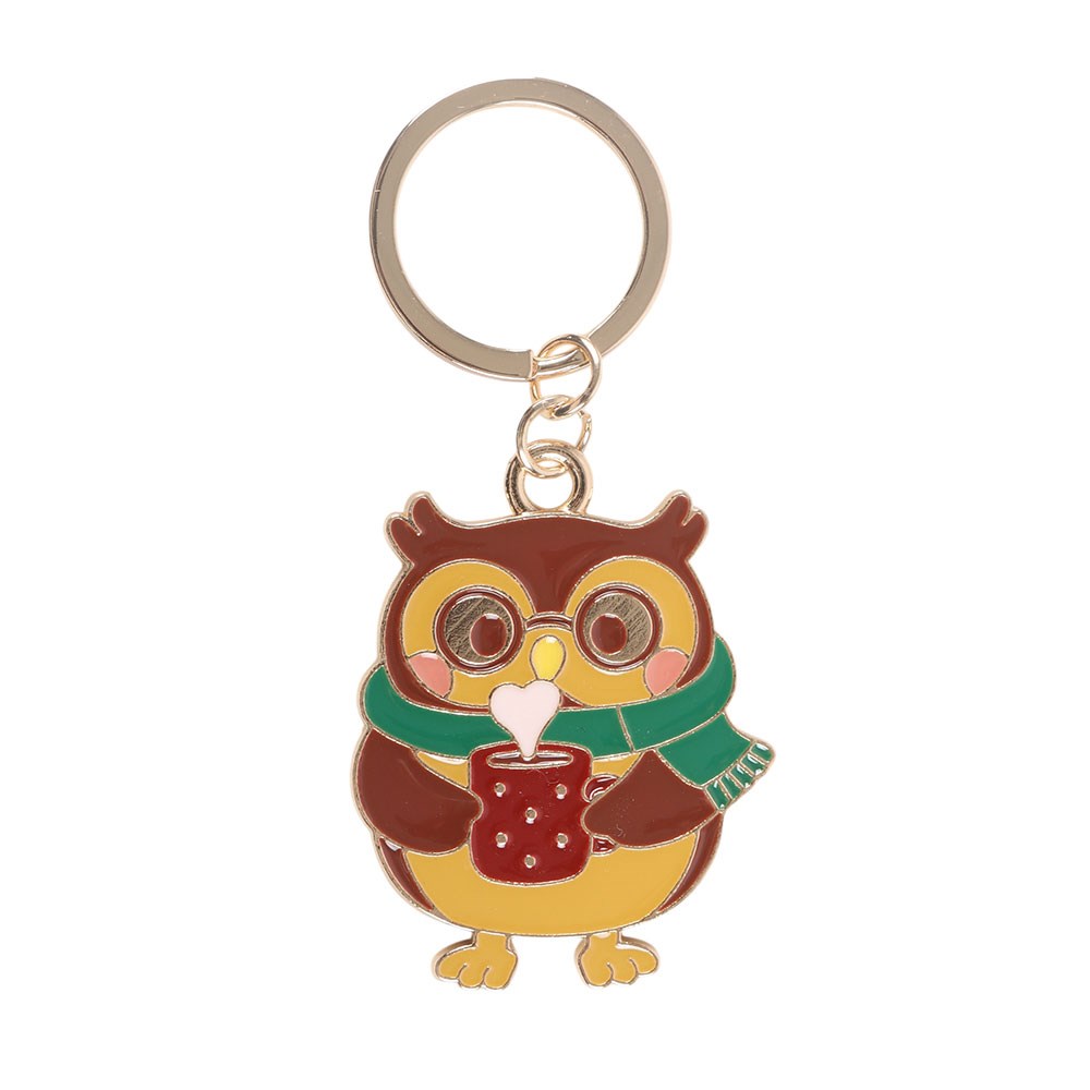 Keychain with an owl design holding a mug on a white background