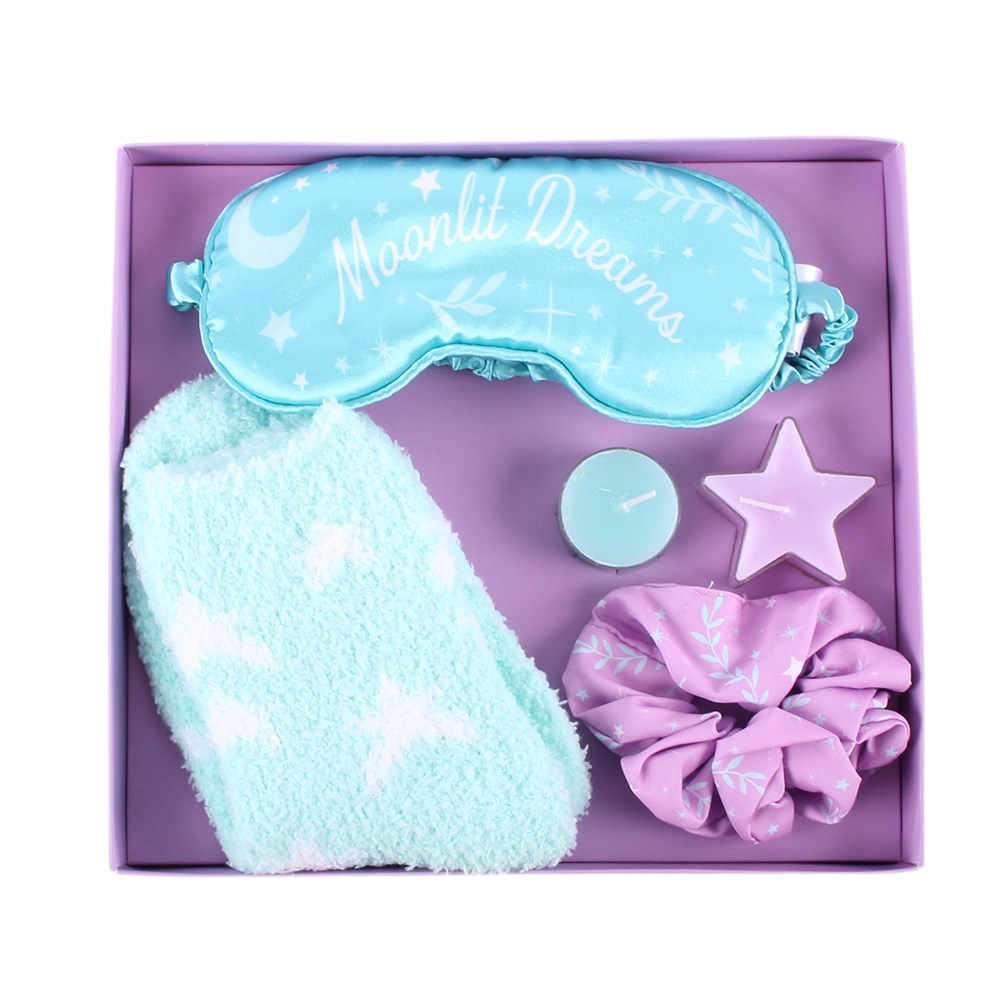 the Pastel Skies Self Care Gift Set. This beautifully coordinated gift set includes polyester socks, a satin eye mask, a satin scrunchie and tealights in a presentation box