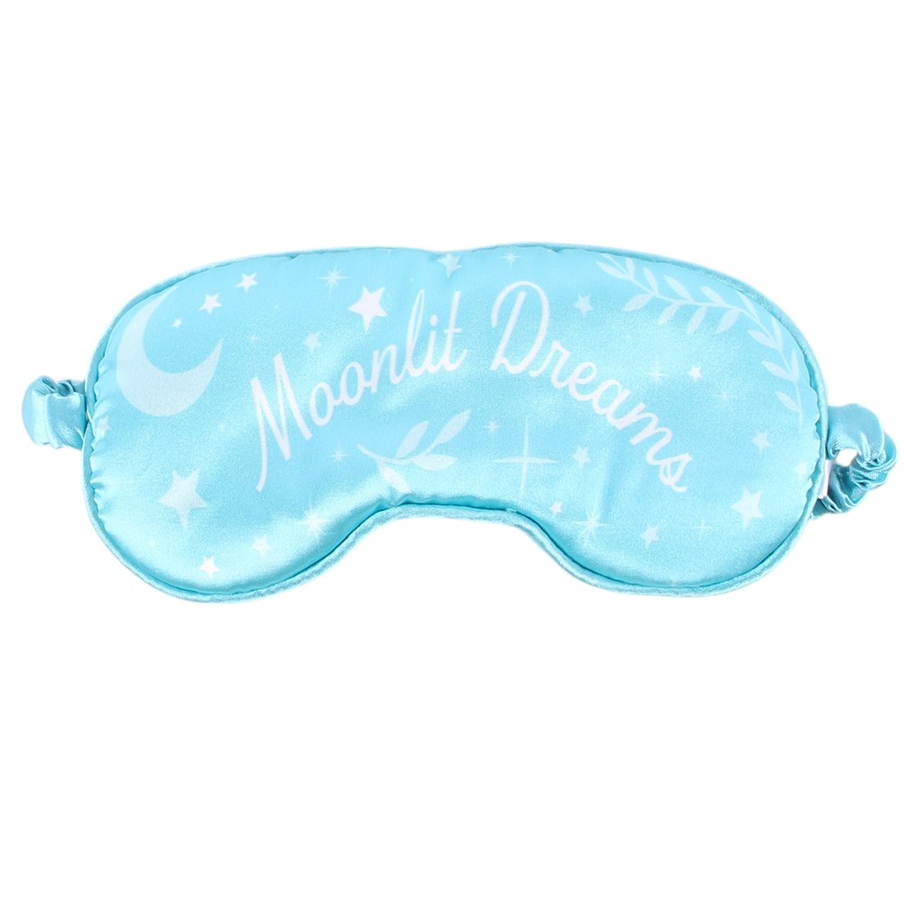 A light blue satin sleep mask with white embroidered stars, a crescent moon, and the words 'Moonlit Dreams' on a plain white background.