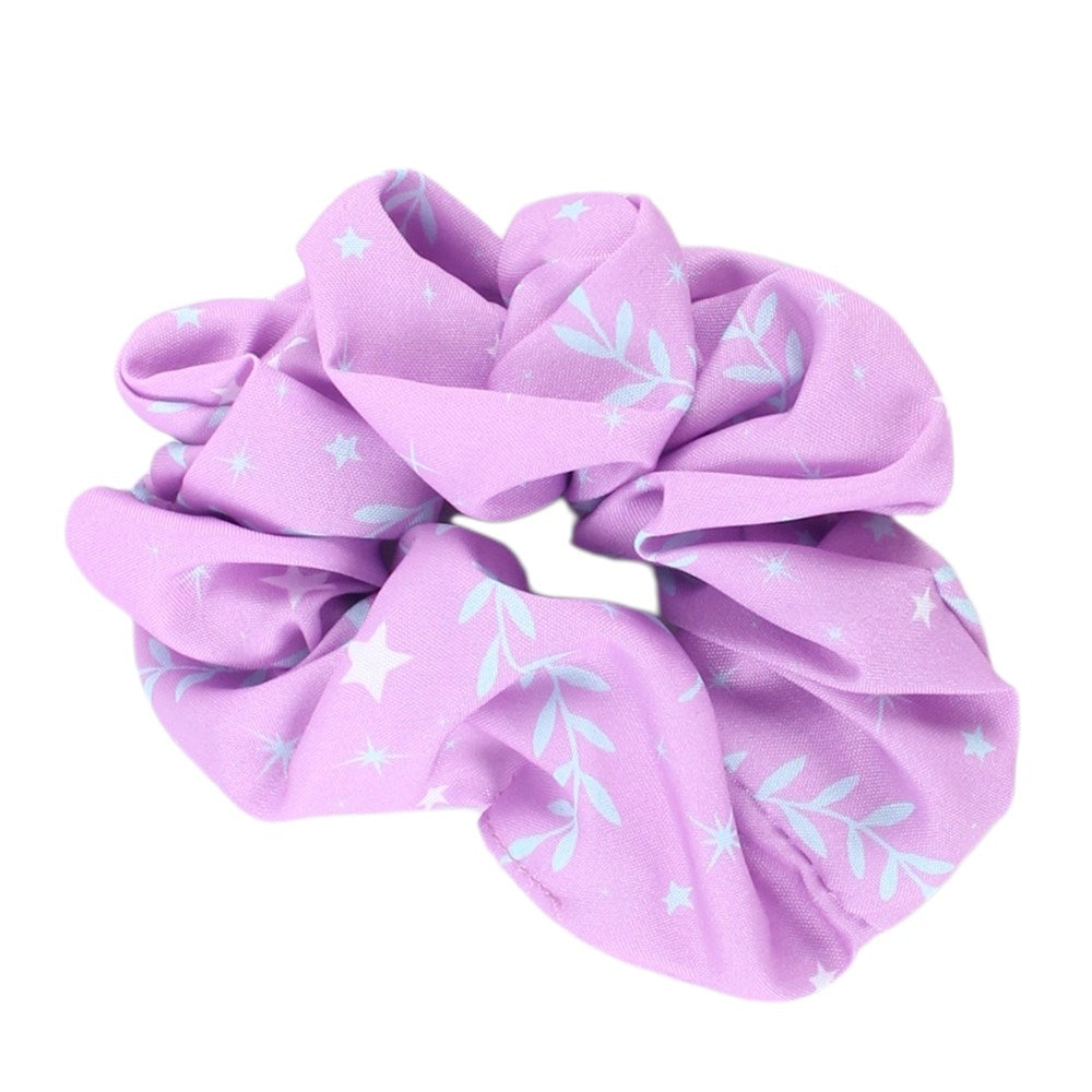 A lavender purple fabric scrunchie with a light blue leaf and star pattern, shown on a plain white background.