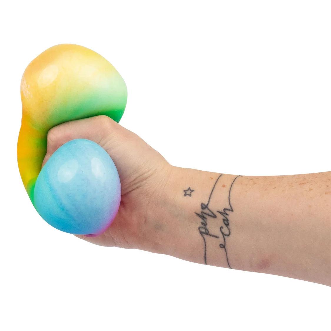 Hand holding a scrunchems dumpling with a rainbow gradient on a white background