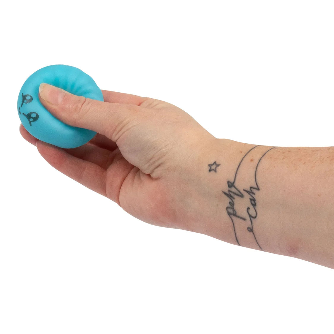 Hand holding a blue scrunchems dumpling with a white background