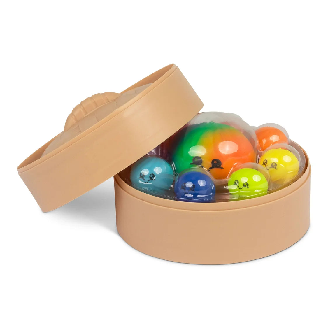 Colourful toy squishy dumplings with faces in a tan container on a white background