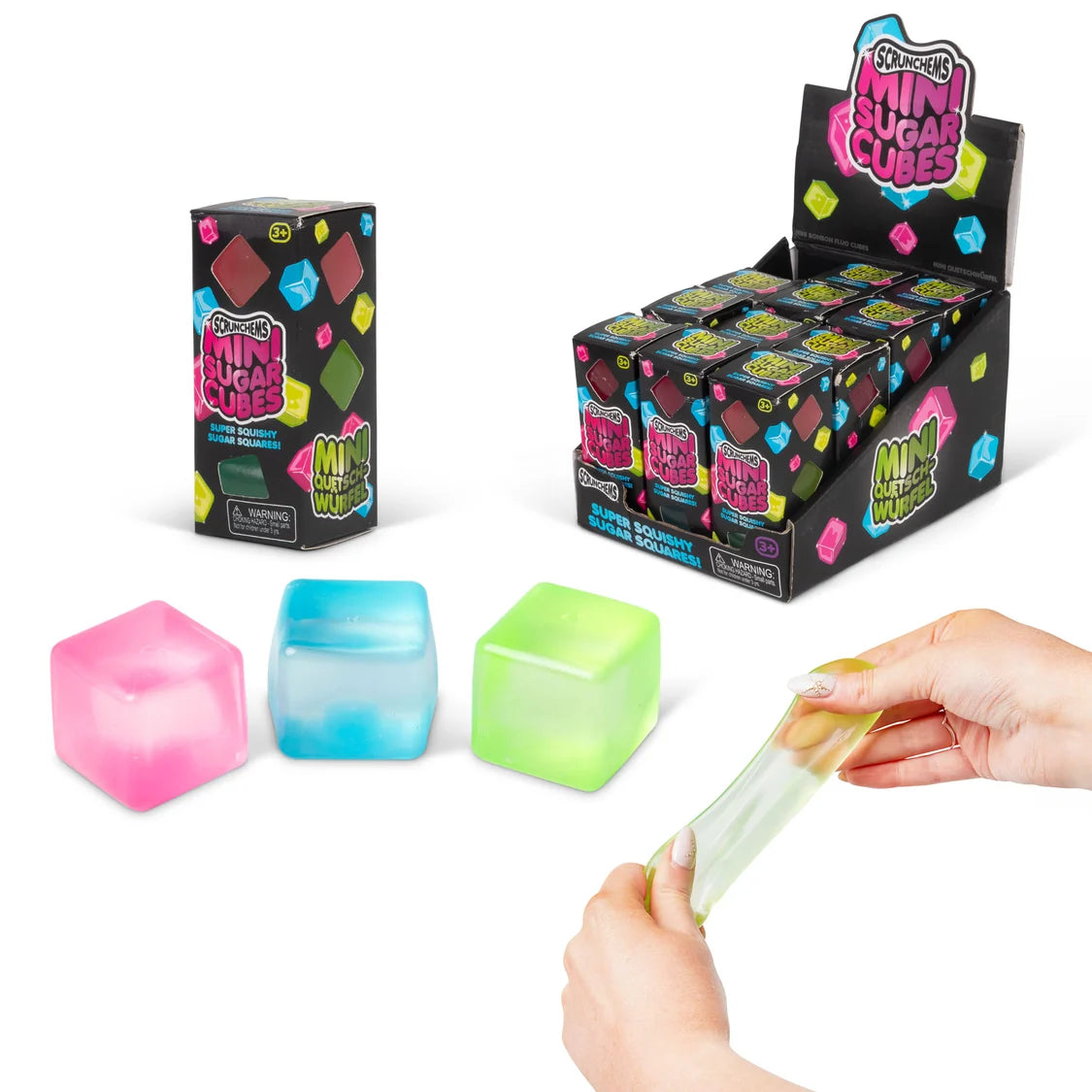Three translucent mini sugar cube toys in pink, blue, and green are shown on a white background, with a person's hands stretching a translucent green cube. A retail display box and a single product box labeled 'Squishy Mini Sugar Cubes' are also visible.