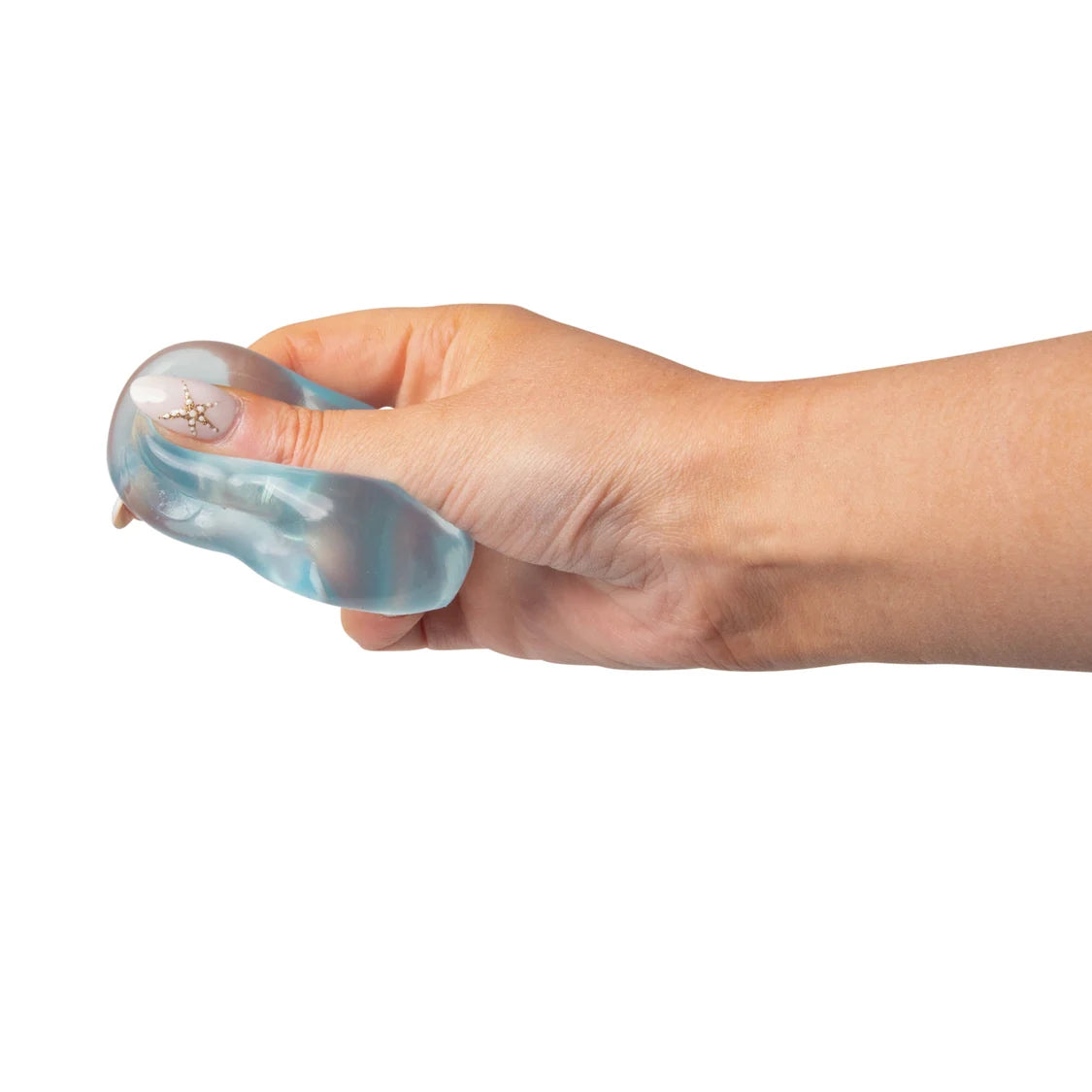 Hand holding a blue sugar cube on a white background