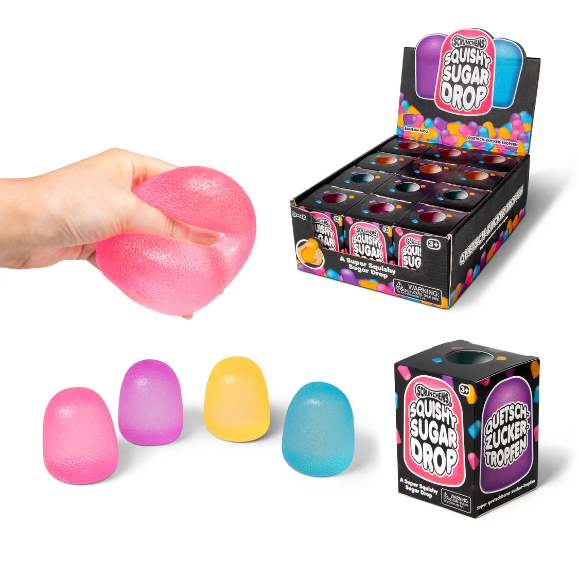 Scrunchems Squishy Sugar Drop toy shown with a hand holding a pink squishy sugar drop fidget, four loose colourful sugar drops, and two retail boxes on a white background.