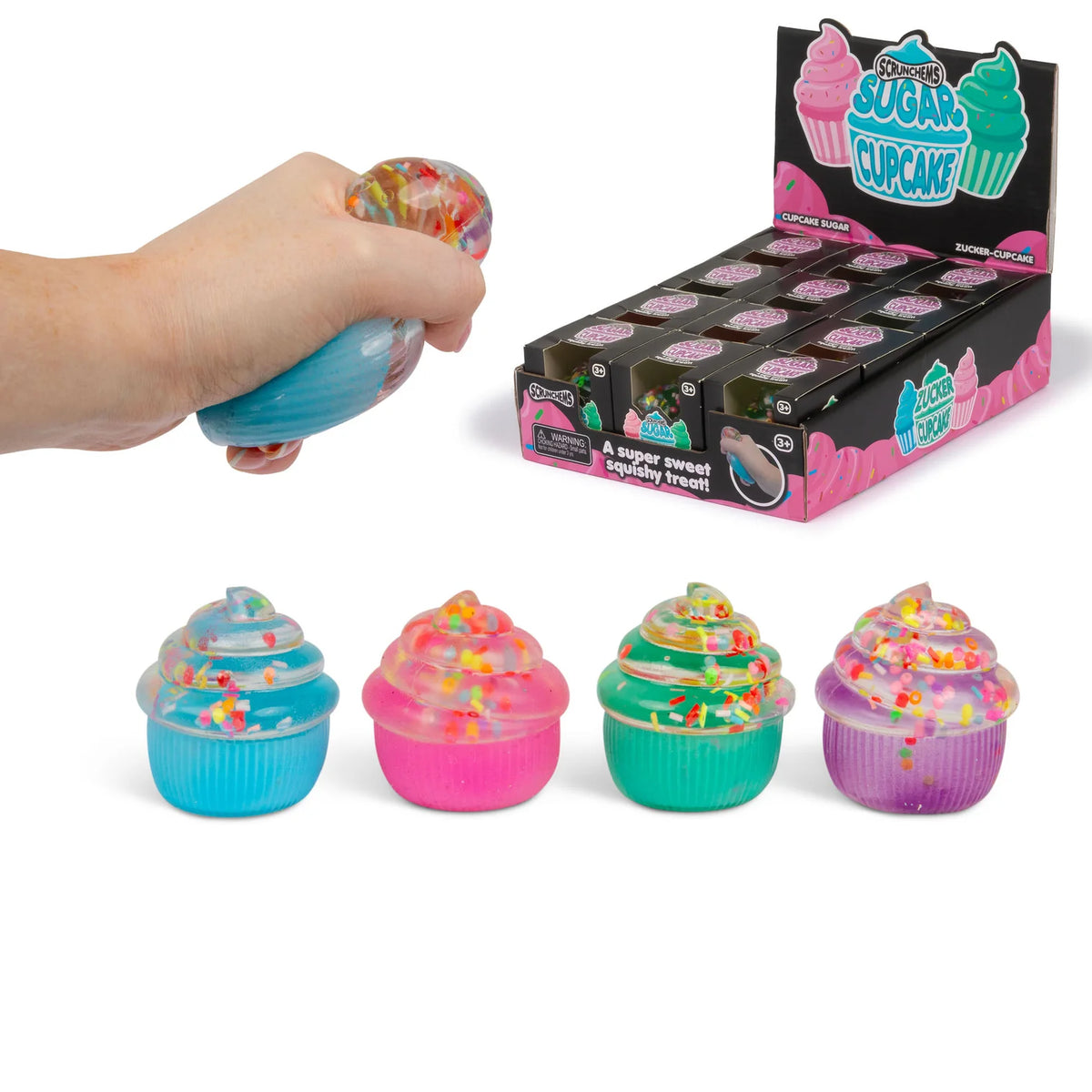 Colorful cupcake-shaped squishies with a hand squeezing one, displayed in front of their packaging.