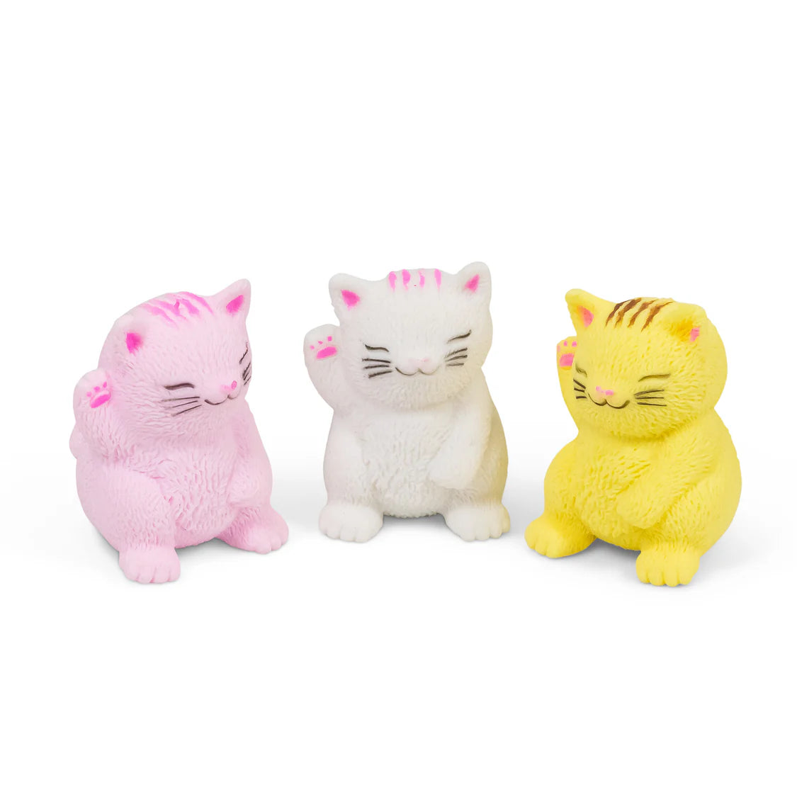 Three small cat-shaped fidgets or squeezy toys in pink, white, and yellow, arranged side by side on a plain white background.
