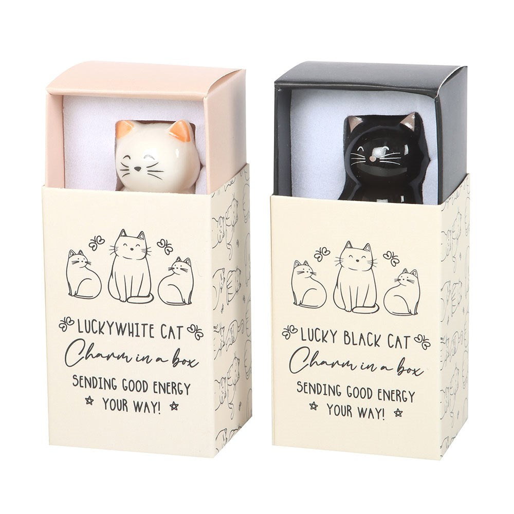 Two cat-shaped charms in packaging with text 'Lucky White Cat' and 'Lucky Black Cat'.